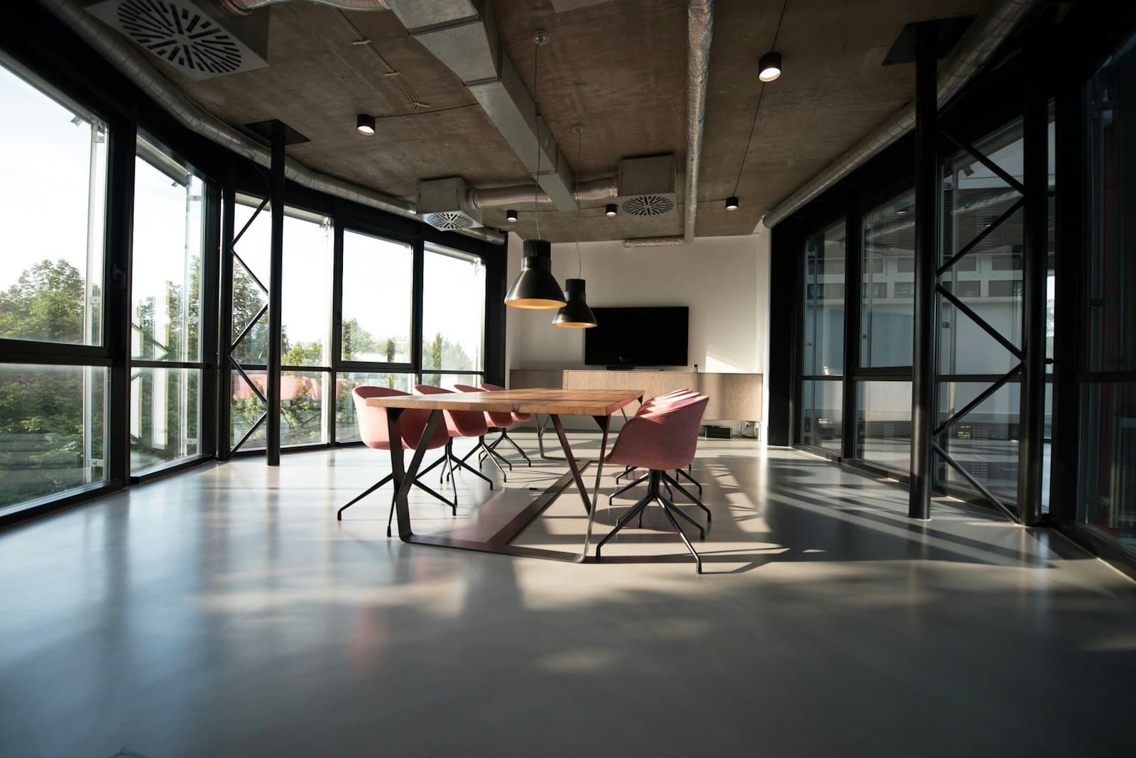 A meeting room in a Gulshan office, with a timber table and a wall of glass.